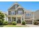 Beautiful two-story home with a brick-and-siding exterior, covered porch, and well-manicured landscaping at 205 Aurora Rd, Hillsborough, NC 27278