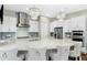 Spacious kitchen featuring a large island, pendant lighting, stainless steel appliances, and ample cabinet space at 205 Aurora Rd, Hillsborough, NC 27278