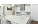 Modern kitchen with a large quartz island, pendant lighting, and stainless steel appliances at 205 Aurora Rd, Hillsborough, NC 27278