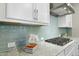 Stylish kitchen with white cabinets, stainless steel appliances, a subway tile backsplash, and granite countertops at 205 Aurora Rd, Hillsborough, NC 27278