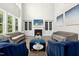 Spacious living room with high ceilings, a fireplace, built-in shelves, and large windows for natural light at 205 Aurora Rd, Hillsborough, NC 27278