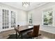 Bright office space with a large window, French doors, and cowhide rug at 205 Aurora Rd, Hillsborough, NC 27278