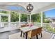 Relaxing screened porch with comfortable seating and outdoor dining area overlooking lush greenery at 205 Aurora Rd, Hillsborough, NC 27278