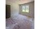 Unfinished bedroom with a large window and natural light, perfect for creating a personalized space at 213 Maye St, Dunn, NC 28334