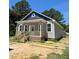Charming exterior showcasing gray siding, a welcoming porch, and well-defined architectural details at 213 Maye St, Dunn, NC 28334