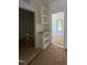Well-lit hallway featuring hardwood floors and convenient built-in shelving at 213 Maye St, Dunn, NC 28334