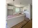 Modern kitchen with white cabinetry, a center island, and stainless steel appliances at 213 Maye St, Dunn, NC 28334
