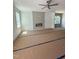 Bright living room featuring a modern ceiling fan, large windows and a cozy fireplace at 213 Maye St, Dunn, NC 28334