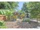 Backyard view of a wooden shed, covered patio, and landscaping at 216 Northwood Cir, Durham, NC 27701