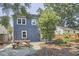 Backyard view of the house with a picnic table on a stone patio and landscaping at 216 Northwood Cir, Durham, NC 27701