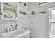 Bathroom featuring a sink, shelves, and paneled walls at 216 Northwood Cir, Durham, NC 27701