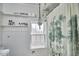 Bright bathroom with paneled walls, a window, and a decorative shower curtain at 216 Northwood Cir, Durham, NC 27701