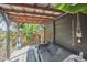 Outdoor workout space on the covered patio with overhead lighting and wooden bench at 216 Northwood Cir, Durham, NC 27701
