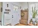 Bright entryway with coat rack, shoe storage, hardwood floors, and white walls at 216 Northwood Cir, Durham, NC 27701