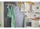 Hallway featuring a modern coat rack with a stylish bag and a green jacket hanging on a black accent wall at 216 Northwood Cir, Durham, NC 27701