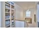 Hallway with storage cabinet, stairs, and a window at 216 Northwood Cir, Durham, NC 27701