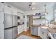 Bright kitchen featuring stainless steel appliances, white cabinetry, wooden countertops, and a farmhouse sink at 216 Northwood Cir, Durham, NC 27701