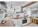 Inviting kitchen with stainless steel appliances, a farmhouse sink, wood countertops, and ample natural light at 216 Northwood Cir, Durham, NC 27701