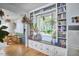 Bright living room with built-in bookshelves surrounding a window and hardwood floors at 216 Northwood Cir, Durham, NC 27701