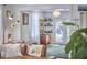 Open living room featuring a couch, bar cabinet, and light-filled entrance to the outdoor space at 216 Northwood Cir, Durham, NC 27701