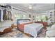 Comfortable main bedroom with a ceiling fan, ample natural light and closet at 216 Northwood Cir, Durham, NC 27701