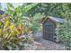 Backyard view of wooden shed surrounded by a landscaped yard at 216 Northwood Cir, Durham, NC 27701