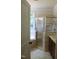 Bright bathroom with a glass shower, soaking tub, and a large window at 221 Grantwood Dr, Holly Springs, NC 27540
