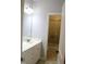 Bathroom showcasing a white vanity and a glimpse into a tiled shower area at 221 Grantwood Dr, Holly Springs, NC 27540