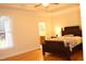Serene bedroom with hardwood floors, tray ceiling, and large window offering natural light at 221 Grantwood Dr, Holly Springs, NC 27540