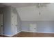 Bonus room with hardwood floors, neutral paint, and a unique ceiling at 221 Grantwood Dr, Holly Springs, NC 27540