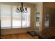 Bright breakfast nook with large windows and a door leading to the outdoor deck at 221 Grantwood Dr, Holly Springs, NC 27540
