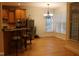 Bright dining area featuring hardwood floors, recessed lighting, and large windows offering ample natural light at 221 Grantwood Dr, Holly Springs, NC 27540