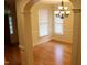 Bright dining room with hardwood floors, large windows, chandelier, and decorative molding at 221 Grantwood Dr, Holly Springs, NC 27540