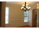 Bright dining room featuring wainscoting, hardwood floors, and an elegant chandelier at 221 Grantwood Dr, Holly Springs, NC 27540