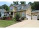 Beautiful home featuring a well-maintained lawn and a spacious driveway leading to a two-car garage at 221 Grantwood Dr, Holly Springs, NC 27540