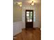 Elegant foyer with hardwood floors, decorative trim, and a stylish front door at 221 Grantwood Dr, Holly Springs, NC 27540