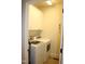 Bright laundry room features storage cabinets, and modern washer and dryer at 221 Grantwood Dr, Holly Springs, NC 27540