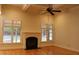 Cozy living room featuring a fireplace, hardwood floors, and plenty of natural light at 221 Grantwood Dr, Holly Springs, NC 27540