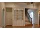 Bright living room with a hardwood floor, staircase, and built in shelving at 221 Grantwood Dr, Holly Springs, NC 27540