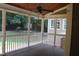 Screened porch with ceiling fan, wood floors and a view of the backyard at 221 Grantwood Dr, Holly Springs, NC 27540