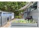 Backyard with a shed, garden, deck, and fire pit, offering outdoor living and storage solutions at 2214 Pathway Dr, Chapel Hill, NC 27516