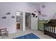 Bedroom showcases a soft lavender palette with access to a bathroom and closet at 2214 Pathway Dr, Chapel Hill, NC 27516