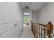 Hallway view featuring storage closet doors and a view into a bedroom with windows at 2214 Pathway Dr, Chapel Hill, NC 27516