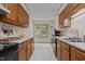 Bright kitchen with white countertops, wooden cabinets, and large windows at 2214 Pathway Dr, Chapel Hill, NC 27516