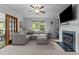 Cozy living room featuring a fireplace, comfortable seating, and large windows for natural light at 2214 Pathway Dr, Chapel Hill, NC 27516
