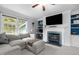 Cozy living room features fireplace with blue accents, built-in shelves, and a comfortable sectional sofa at 2214 Pathway Dr, Chapel Hill, NC 27516