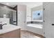Beautiful bathroom with a large tub, walk-in shower with glass enclosure, and double vanity sinks at 222 Cherrybirch Ln, Zebulon, NC 27597