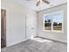 A spacious bedroom featuring a double-door closet, a ceiling fan, and a window with outside views at 222 Cherrybirch Ln, Zebulon, NC 27597