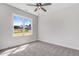 A well-lit bedroom with neutral walls, carpet flooring, and a large window with neighborhood views at 222 Cherrybirch Ln, Zebulon, NC 27597