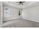 Spacious bedroom with neutral carpet, a ceiling fan, and two large windows for ample natural light at 222 Cherrybirch Ln, Zebulon, NC 27597